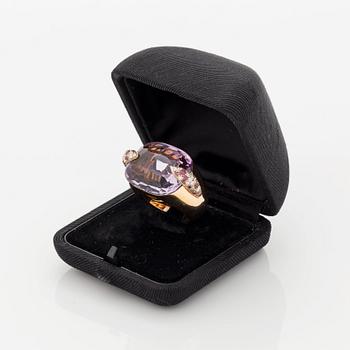 A Pomellato ring set with amethysts and round brilliant-cut diamonds.