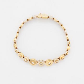 A 14K gold bracelet set with round brilliant-cut diamonds.