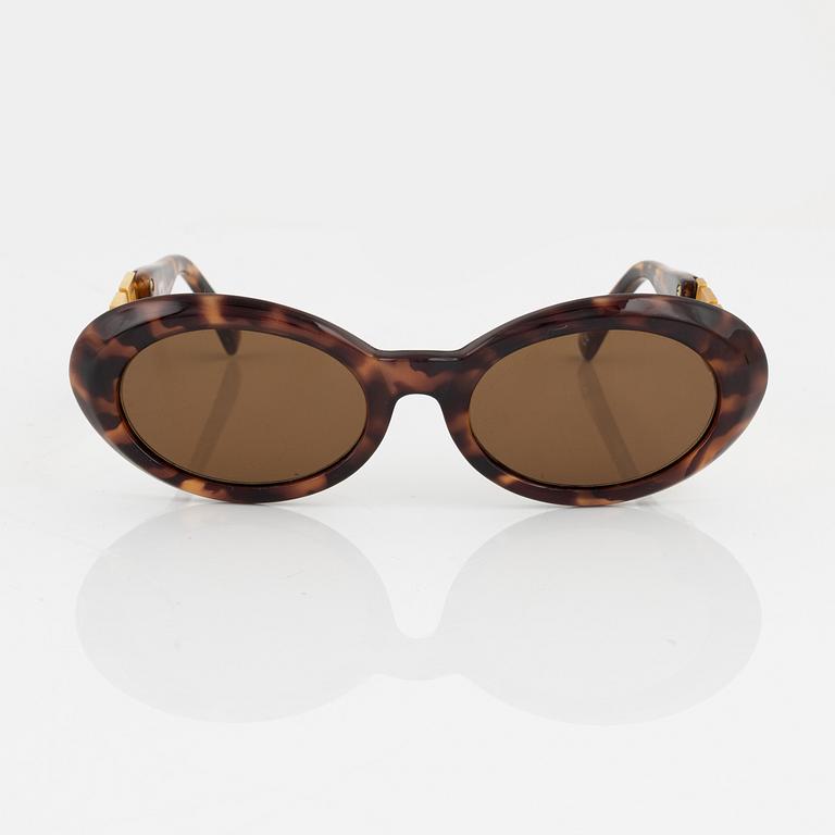 Gianni Versace, a pair of brown and gold sunglasses.