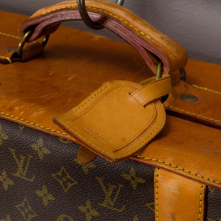 A Louis Vuitton vintage Monogram Canvas Homme Garment Bag.