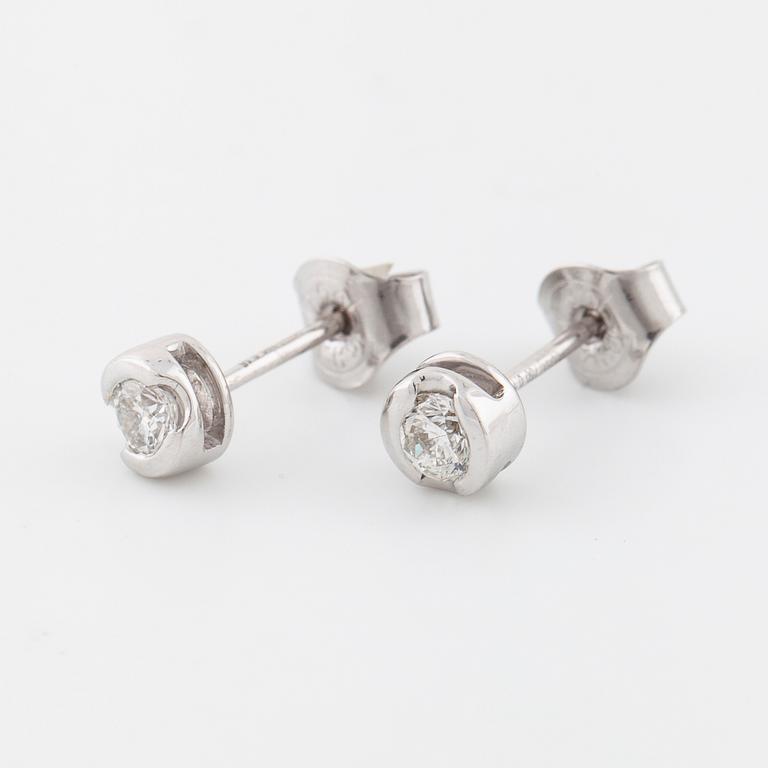 A pair of brilliant cut diamond earrings.