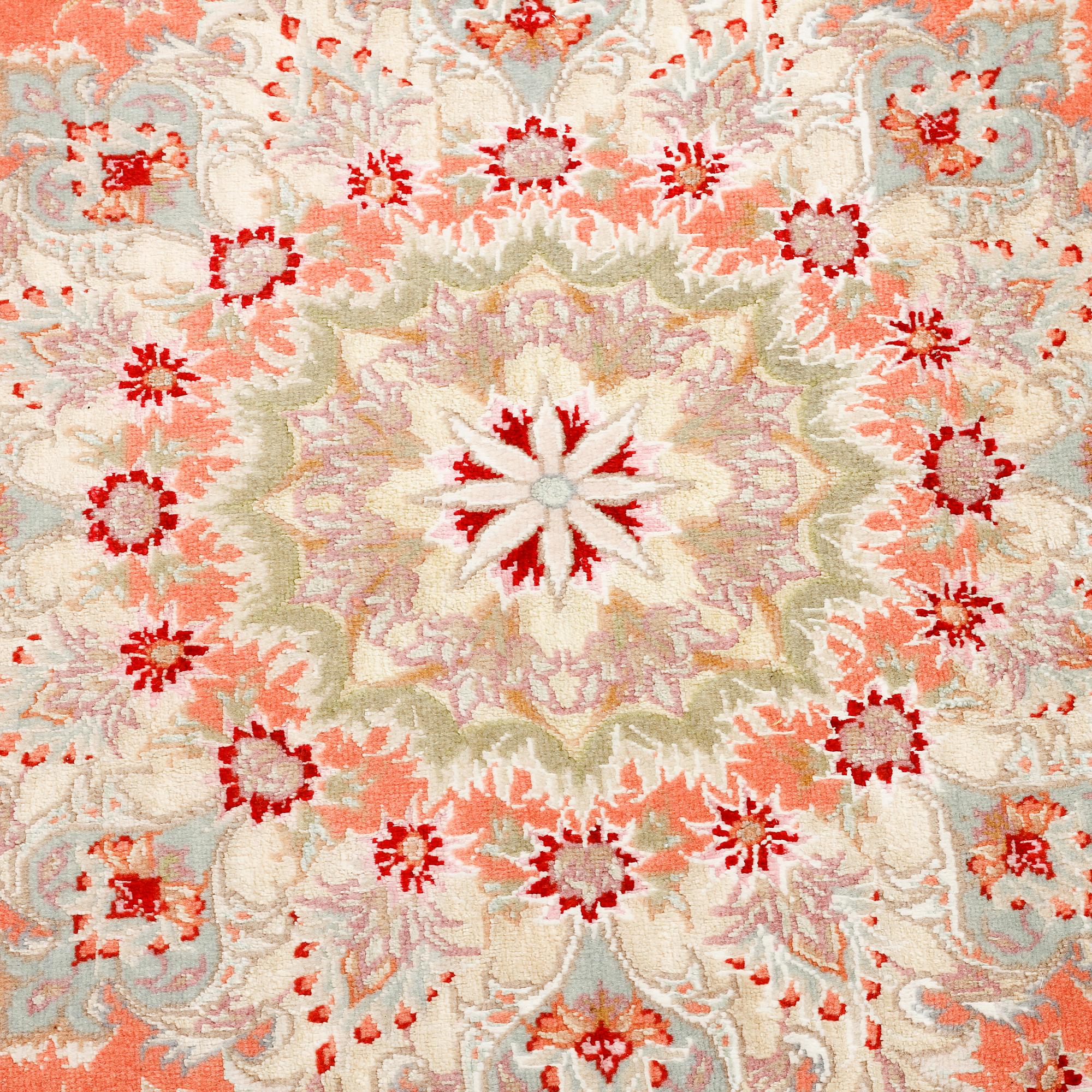 A Täbriz rug, signed, part silk, 210 x 148 cm.