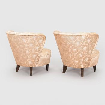 A pair of mid-20th century armchairs.