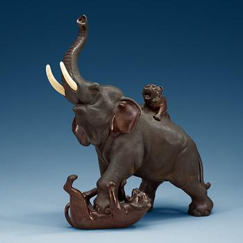 1498. A Japanese bronze and ivory figure of an elephant attacked by two tigers, Meiji, ca 1900.