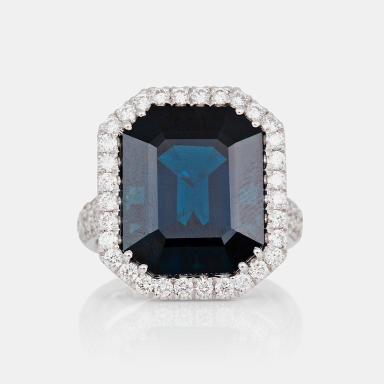 A ring set with a dark greenish-blue sapphire, 16.40 cts, surrounded by 1.08 ct pavé-set brilliant-cut diamonds.