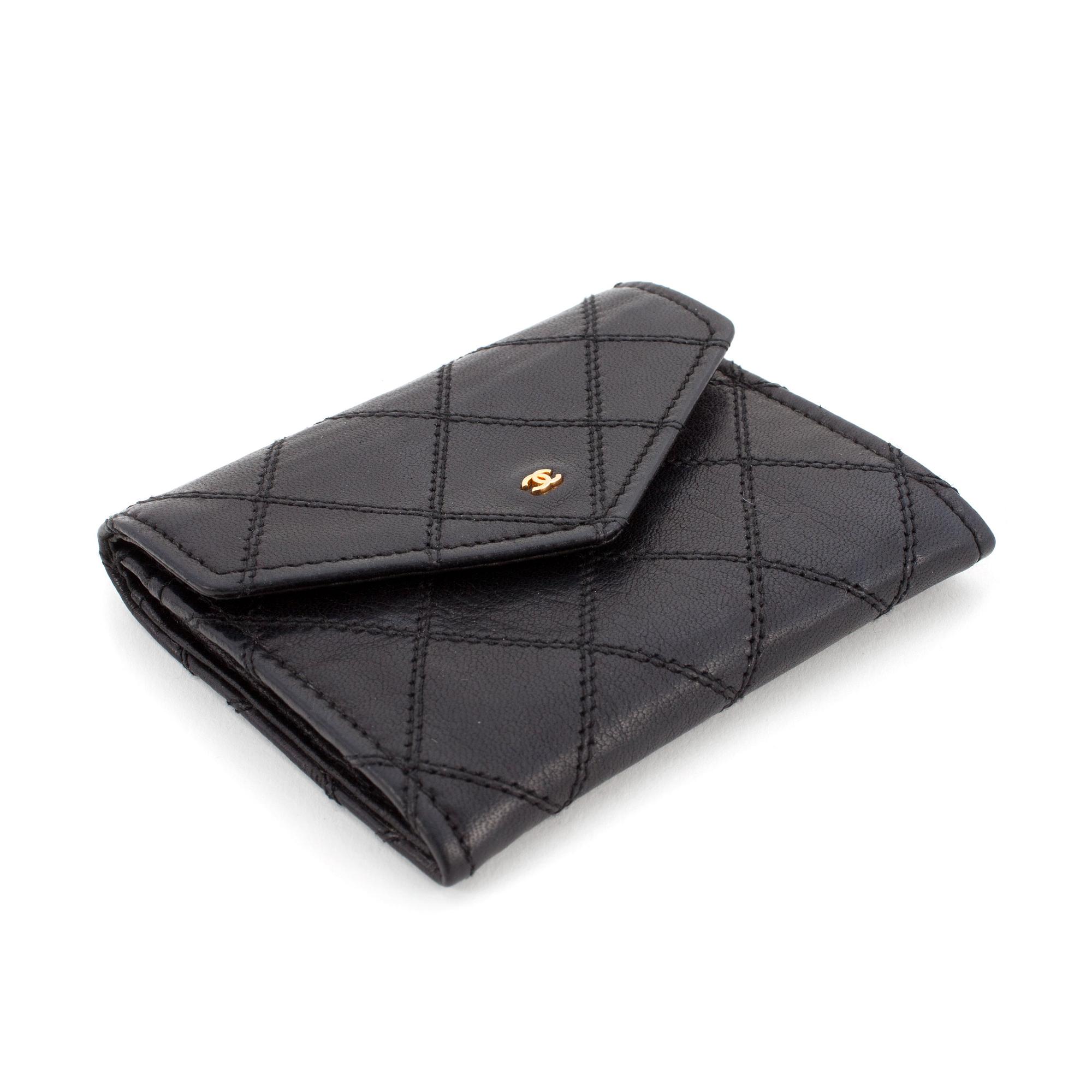 CHANEL, a black quilted leather coin purse.