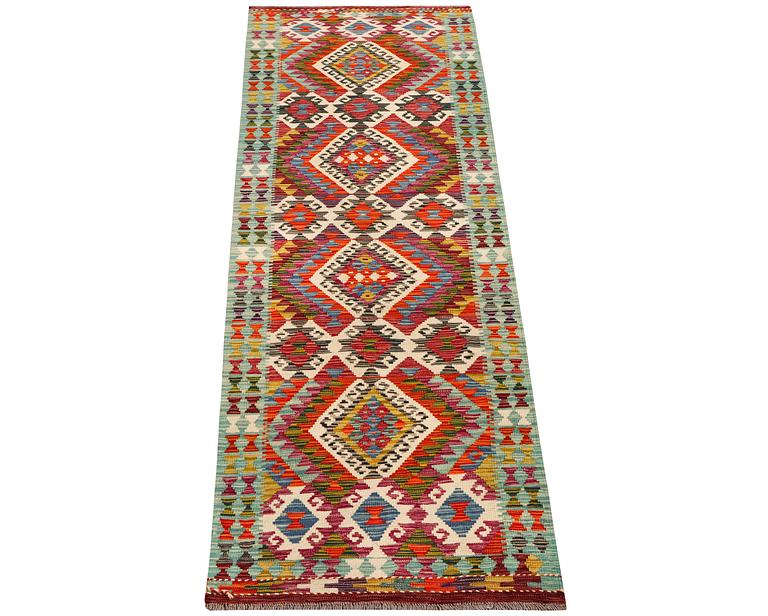 An Afghan kilim runner, c. 294 x 82 cm.