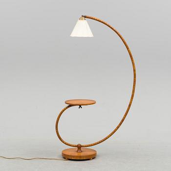 A first half of the 20th century floor lamp with table.
