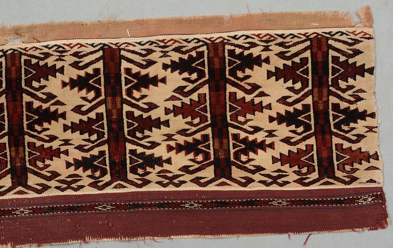 ANTIQUE TURKMEN FRAGMENT. Probably fragment of a kapunuk or a jollar. 24 x 130 cm.