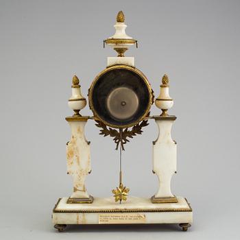 A Louis XVI marble and bronze mantel clock from the second half of the 18th century.