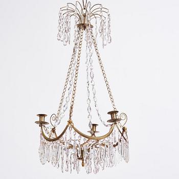 A Gustavian gilt brass and cut glass four-light chandelier, Stockholm, late 18th century.