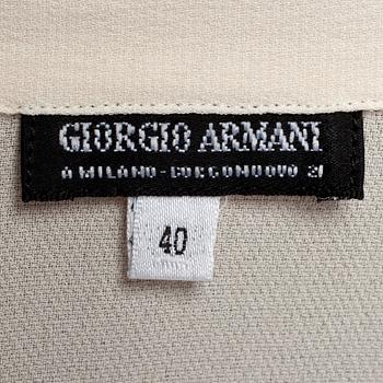 GIORGIO ARMANI, a light beige silk blouse.