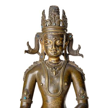 A bronze figure of a crowned buddha, Tibet, 14th Century.