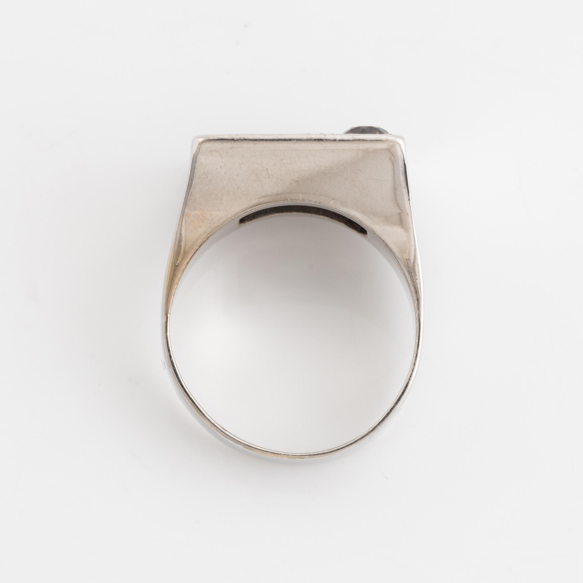 An 18K white gold ring set with round brilliant-cut diamonds and colored stones.