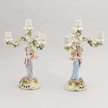 A pair of porcelain rococo style candelabra and a centerpiece bowl, Plaue, Germany, first half of the 20th century.