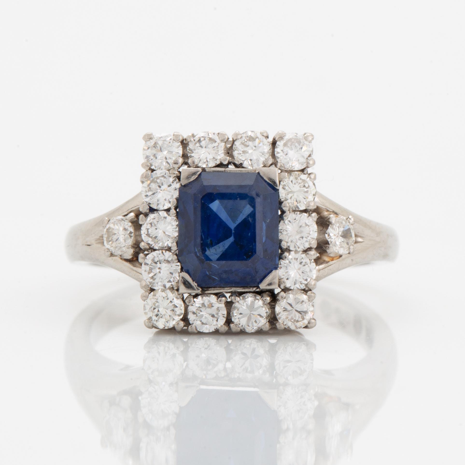 A platinum ring set with a faceted sapphire.