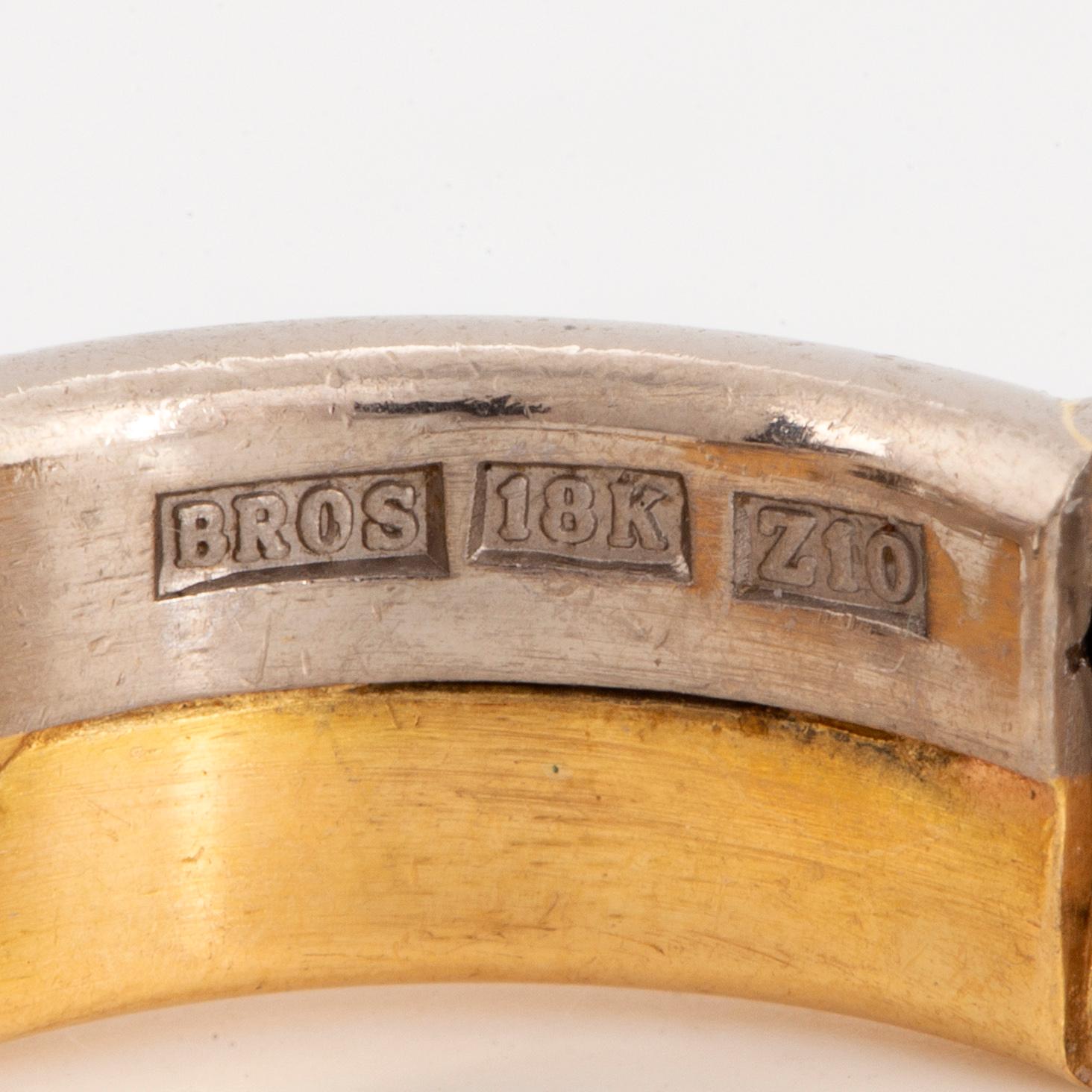 Heart-shaped diamond hoop earrings.