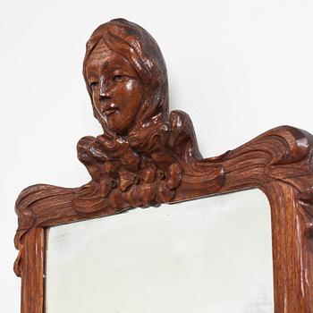 An Art Nouveau oak wall mirror with a console table.