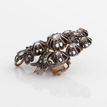 A silver brooch set with rose-cut diamonds.