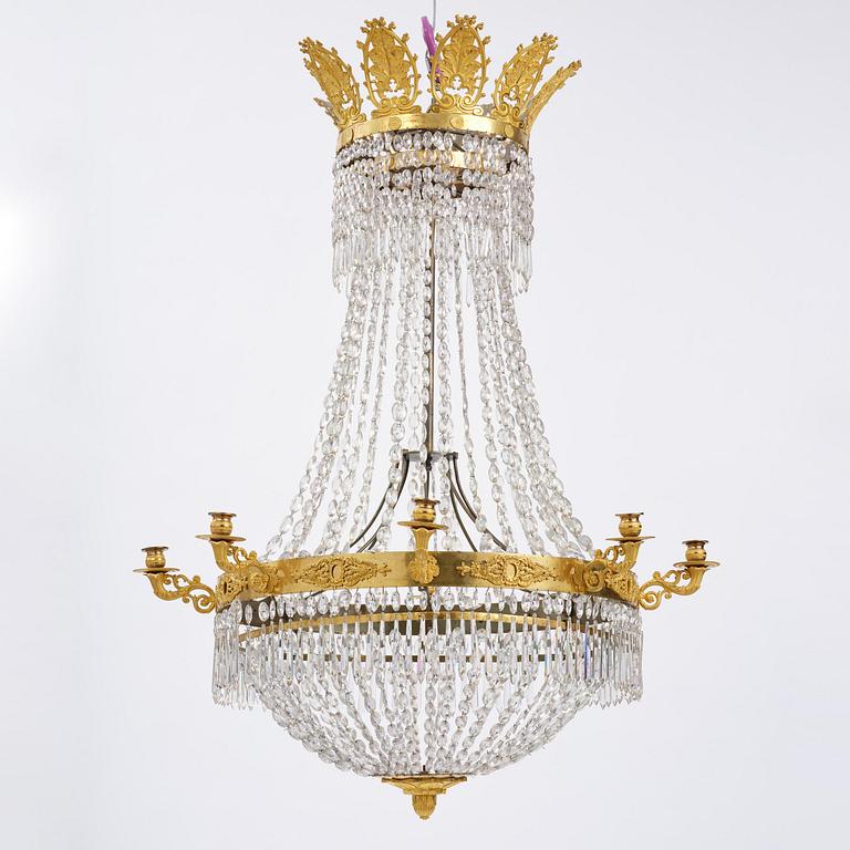 An French Empire eight-light gilt-brass and cut-glass chandelier.
