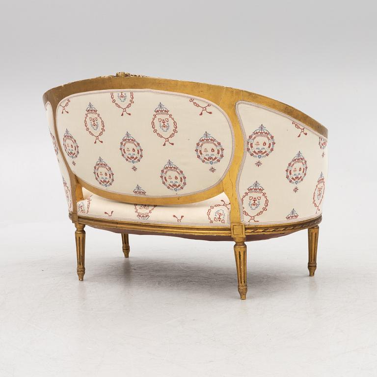A Gustavian style sofa with two armchairs and two chairs, 20th century.