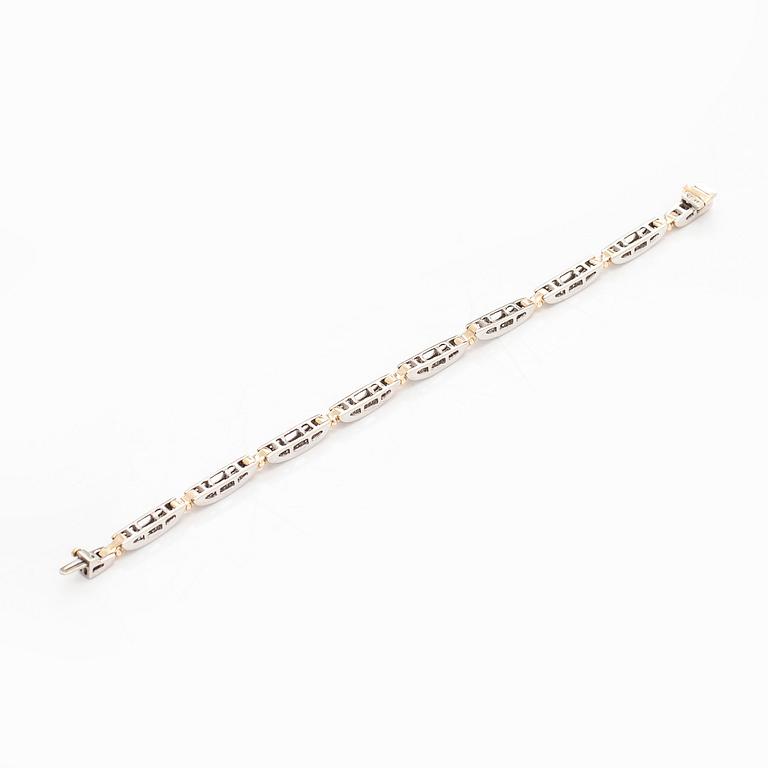 A 14K gold/white gold bracelet set with princess- and baguette-cut diamonds.