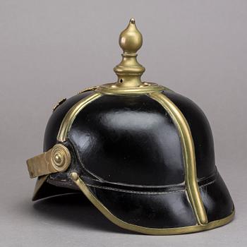 POLICE HELMET AND EPAULETTES AROUND 1900.