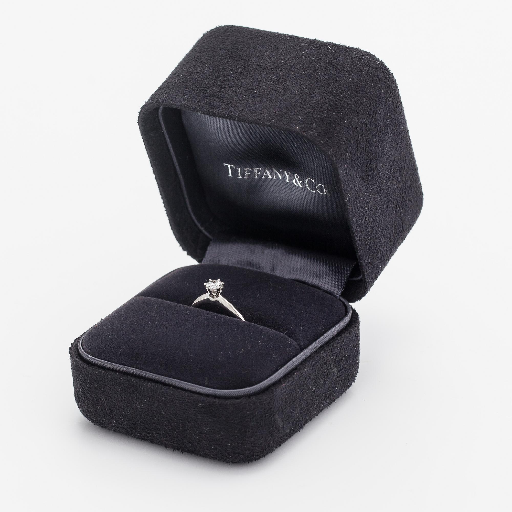 Tiffany & Co, A platinum ring with a ca. 0.26 ct diamond.