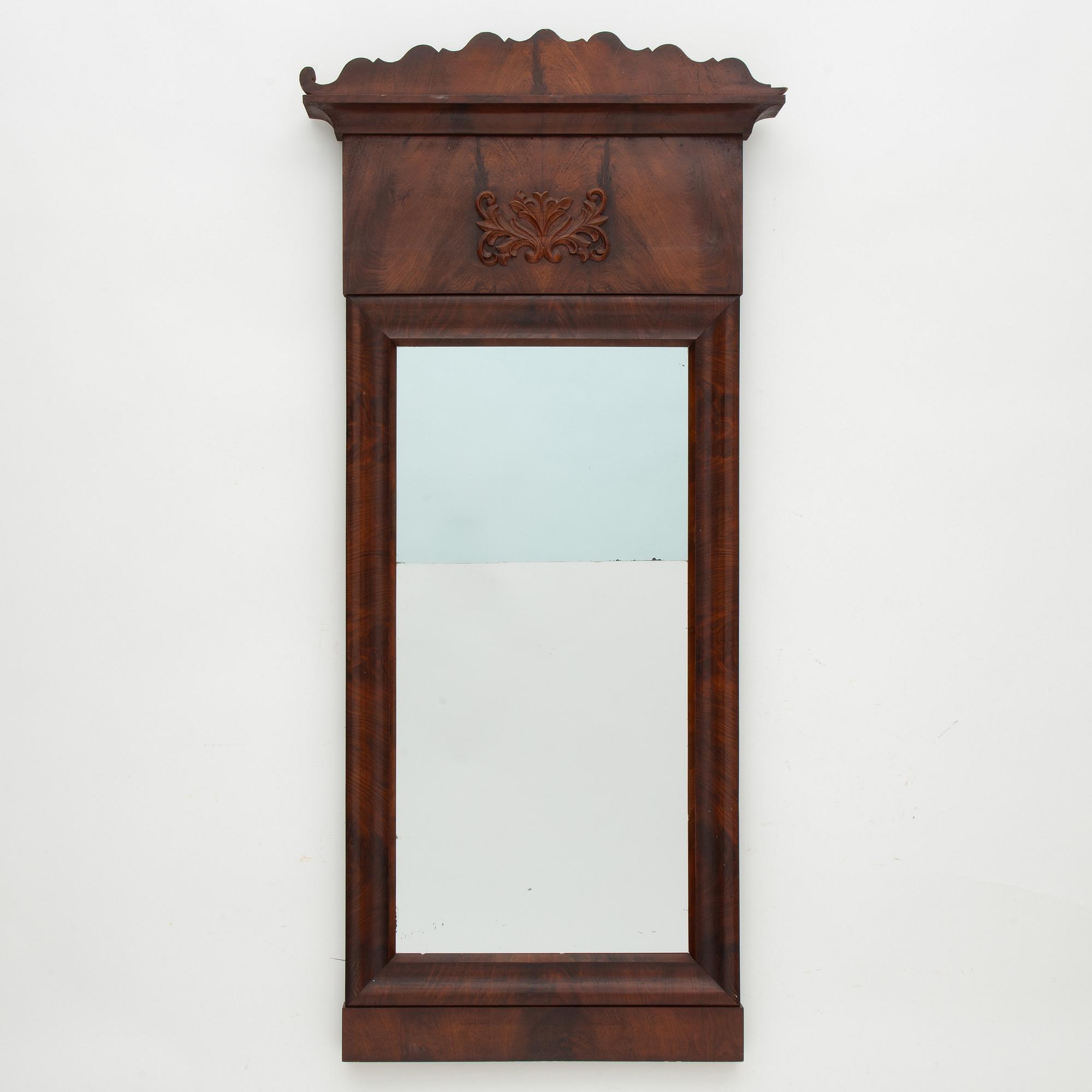A Swedish Empire mirror with a console table, first half of the 19th Century.