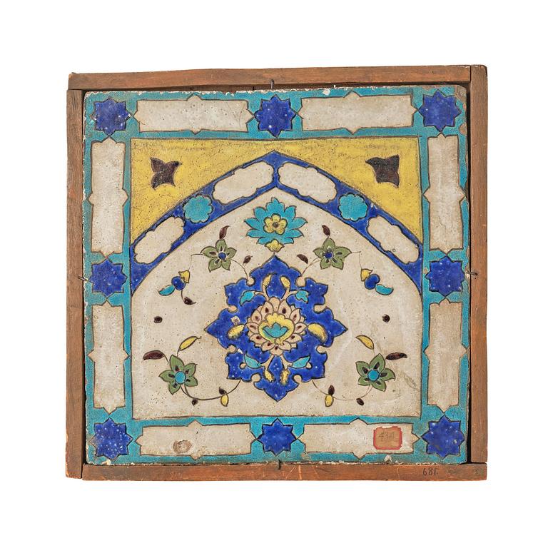 A 'cuerda seca' pottery tile, c. 39 x 40 cm (with mounting 44 x 44 cm), Persia (Iran), the Qajar dynasty (1789–1925).