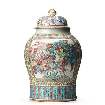 750. A Canton famille rose jar with cover on a tall wooden stand, Qing dynasty, late 19th Century.