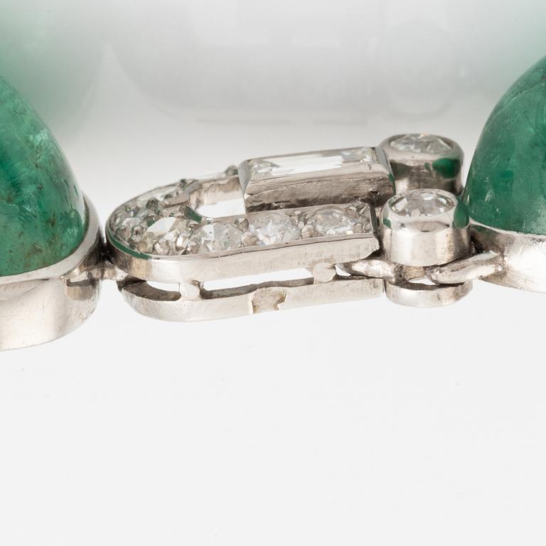 An art deco platinum necklace/bracelet combination with cabochon-cut emeralds.