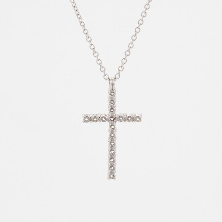 Brilliant-cut diamond cross pendant.