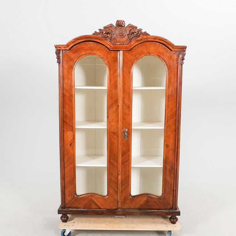 A walnut display cabinet around 1900.