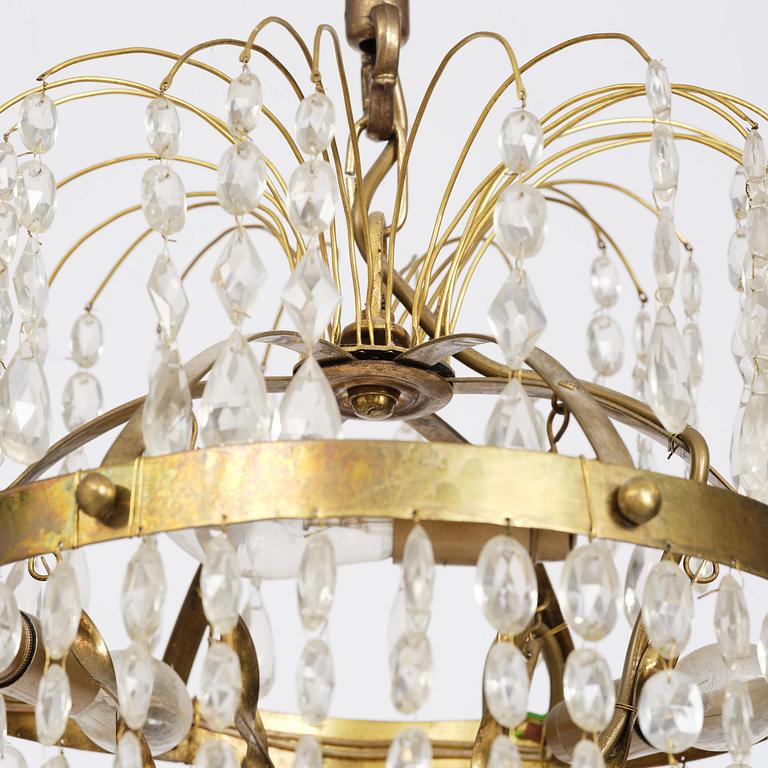 A Swedish gilt brass and cut glass thirteen-light Empire chandelier, early 19th century.
