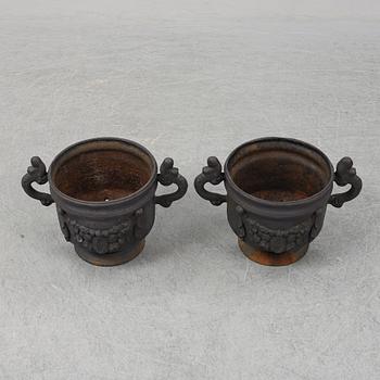 A 20th Century pair of cast iron flower pots.