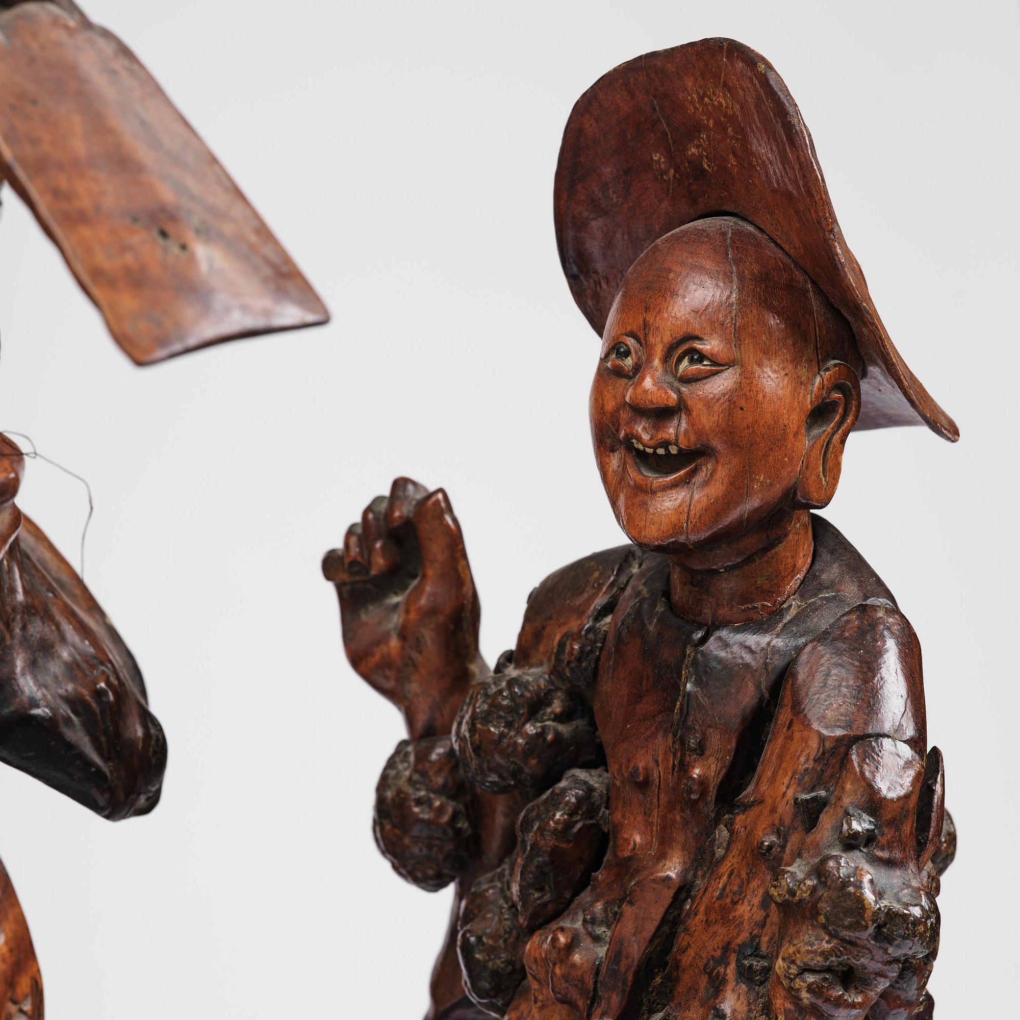 A large well sculptured root sculpture of 'Sholau and attendant', late Qing dynasty, 19th century.