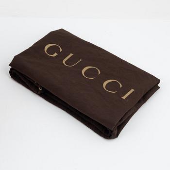 Gucci, a leather handbag.