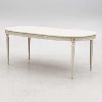 A Gustavian style dining table and eight chairs, late 20th century.