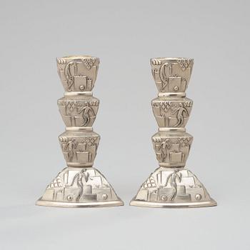 A pair of white metal candlesticks, 1920-30's.