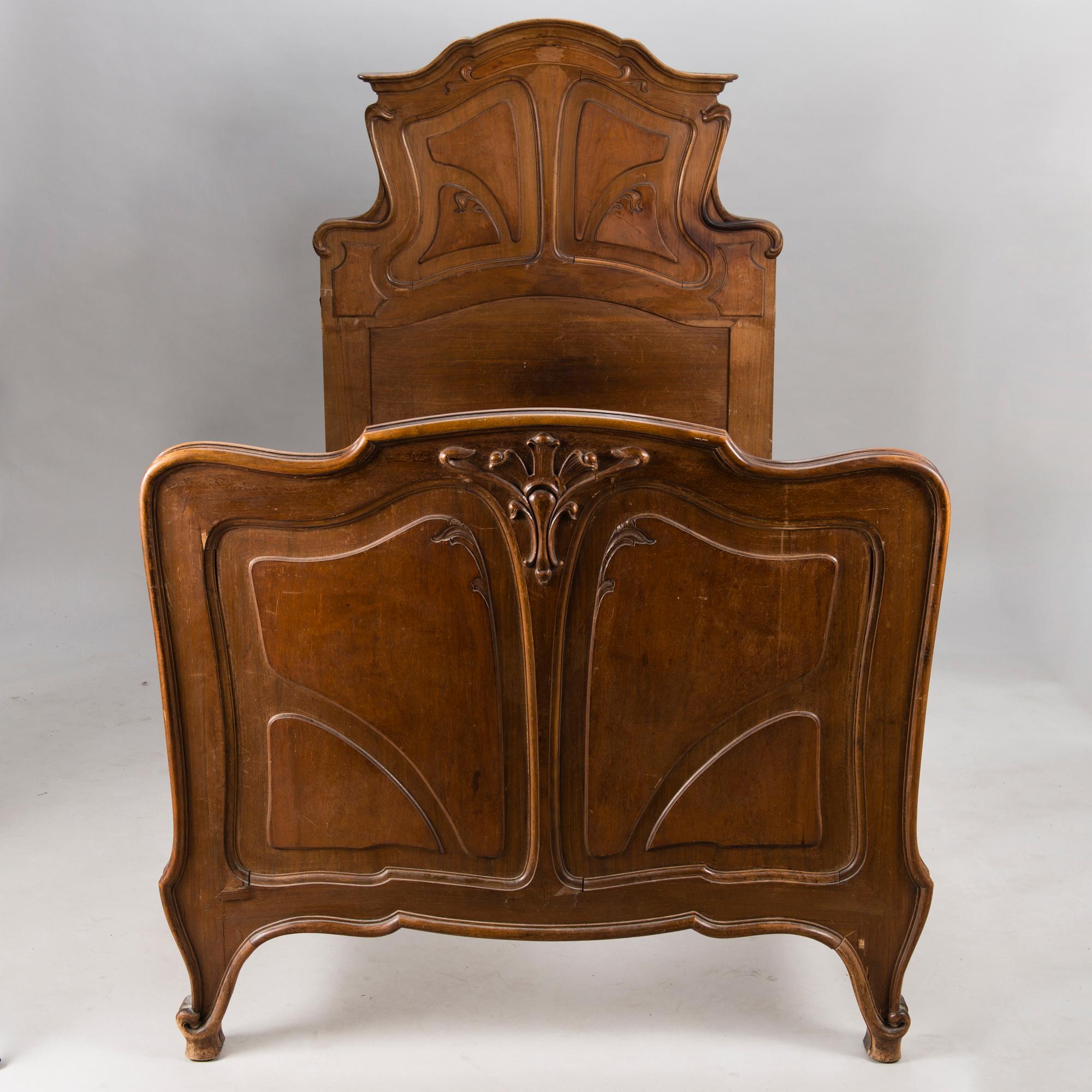 A pair of early 20th Century art nouveau style beds.