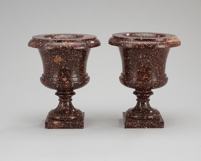 A pair of Swedish first half 19th century porphyry urns.