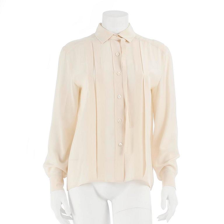 CÉLINE, a créme colored silk blouse.