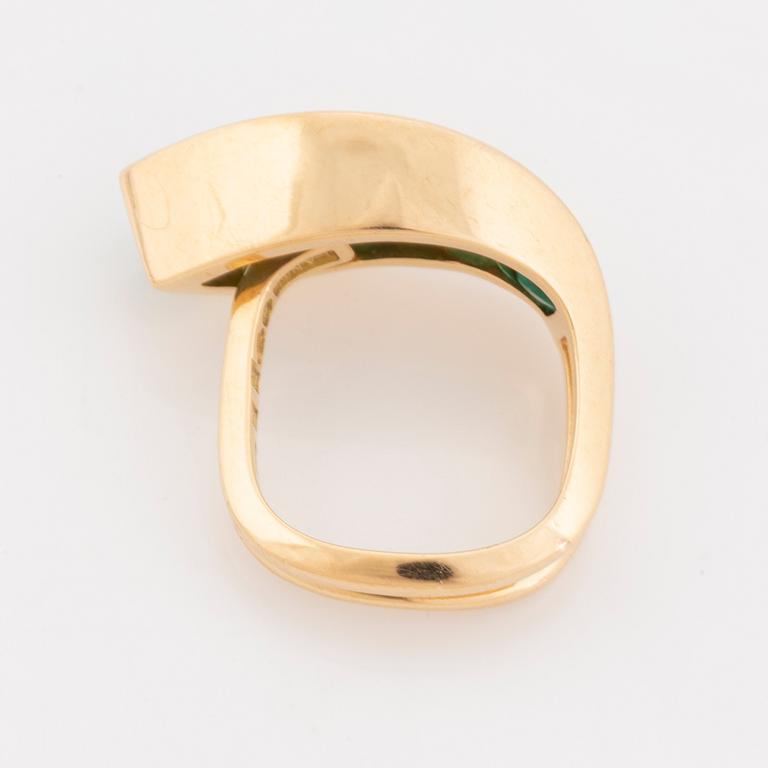 An 18K gold Lantz ring set with step-cut emeralds.