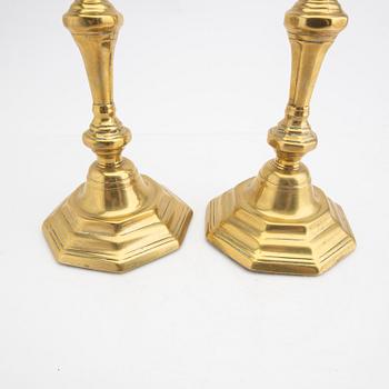 A pair of 18th century brass candle sticks.