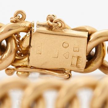 An 18K gold bracelet.