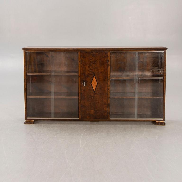 A 1930s birch book cabinet.