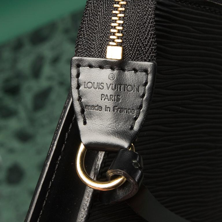 A bag  "Pochette Accessoires" by Louis Vuitton.