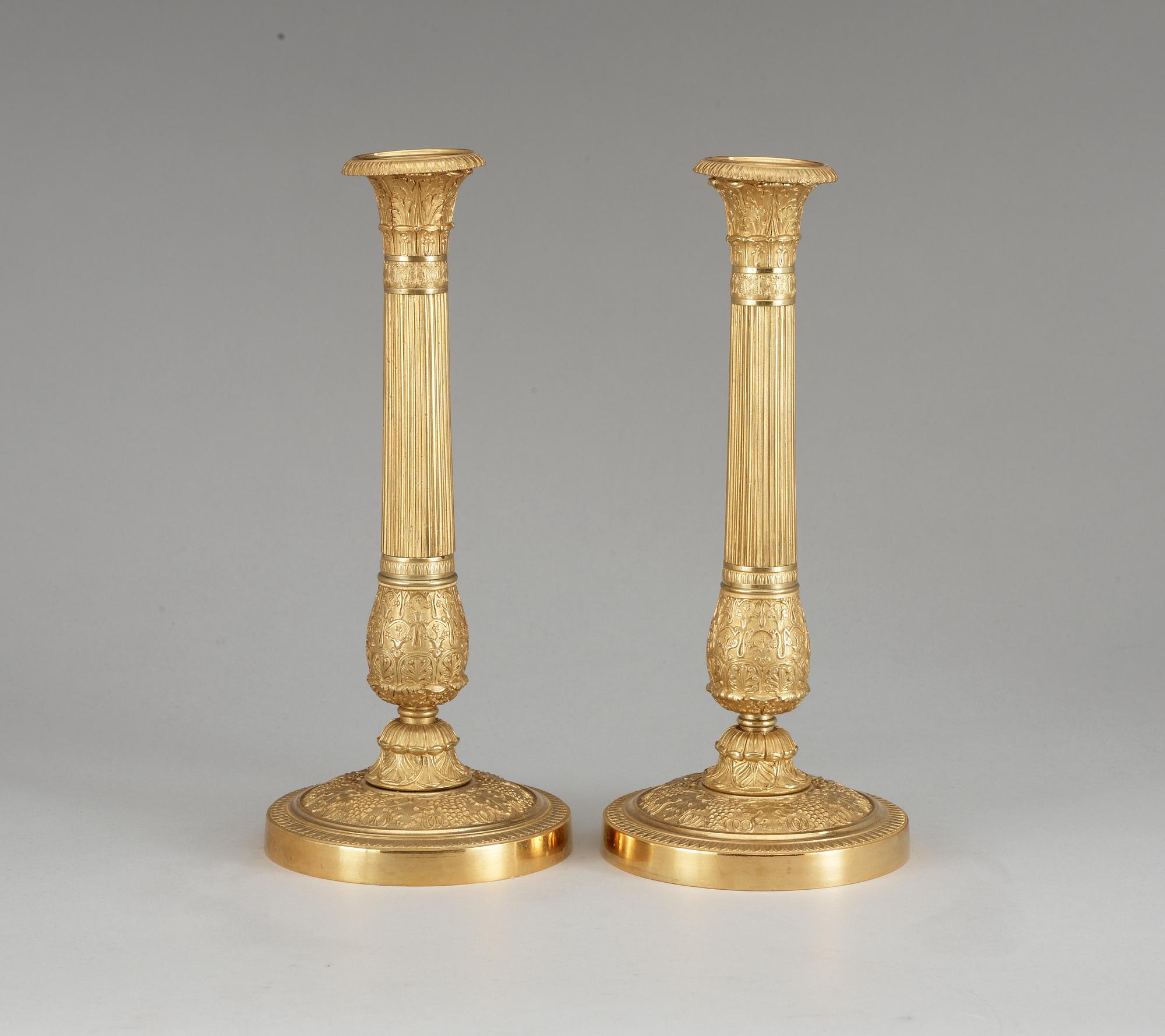 A pair of French Empire early 19th century candlesticks.