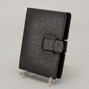 A Louis Vuitton palm pilot leather cover.